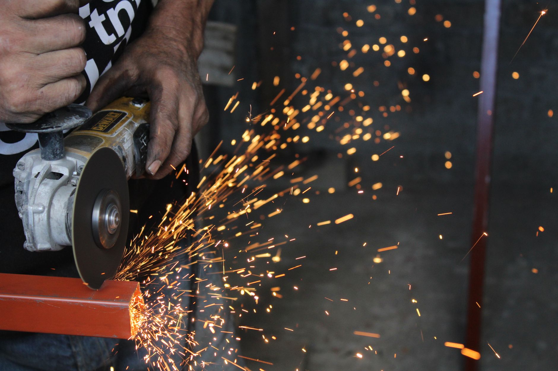 Angle grinder cutting metal with sparks