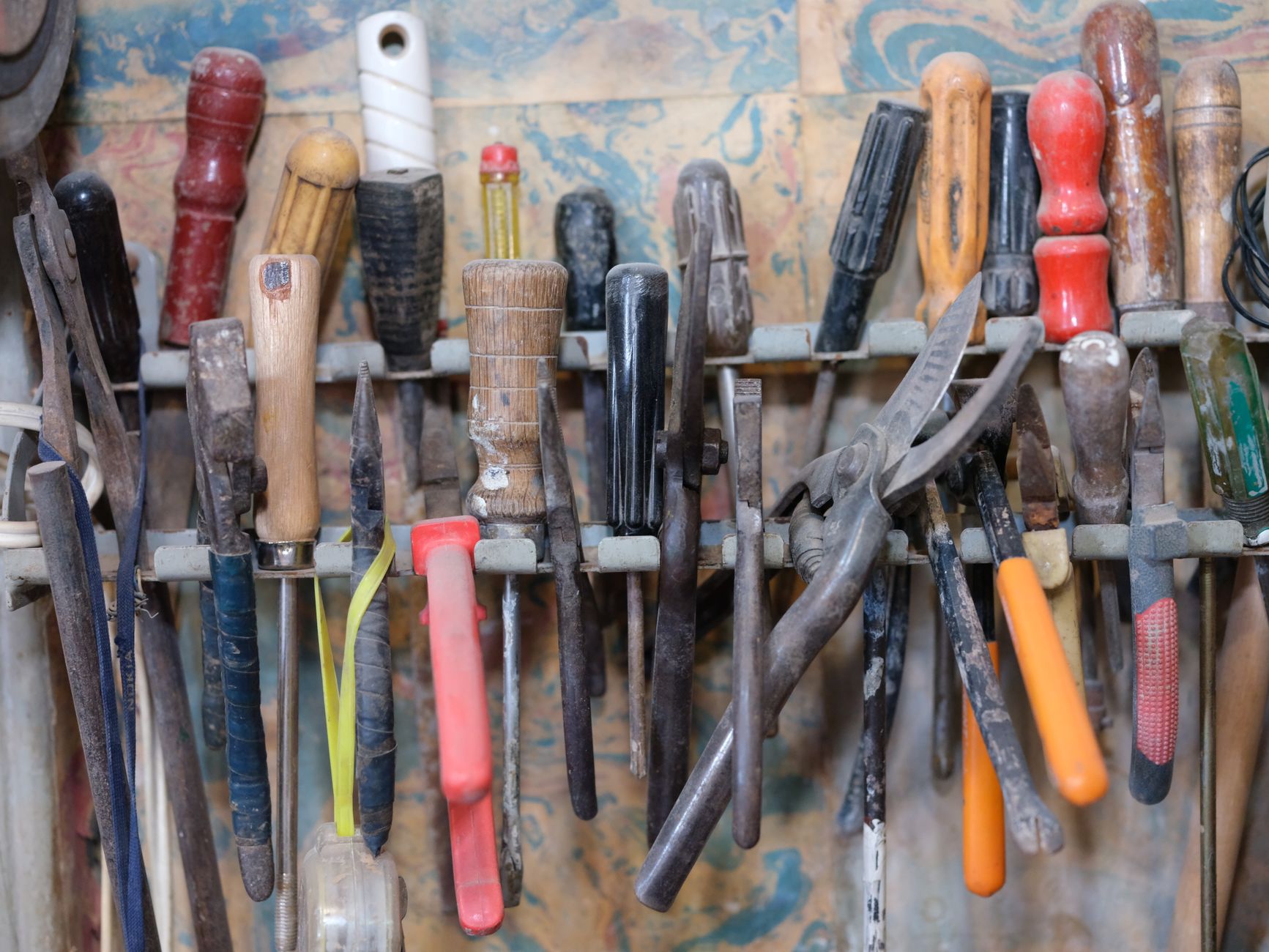 Hand tools organised on a workshop rack